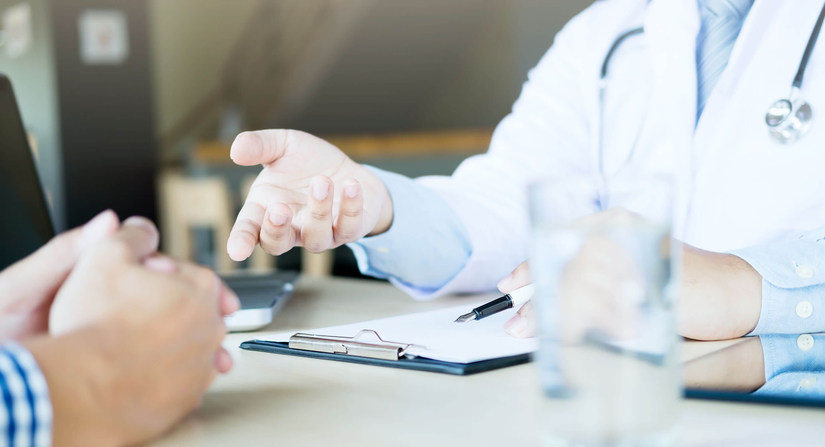 Image showing close-up of doctor and patient hands while they talk in doctor's office