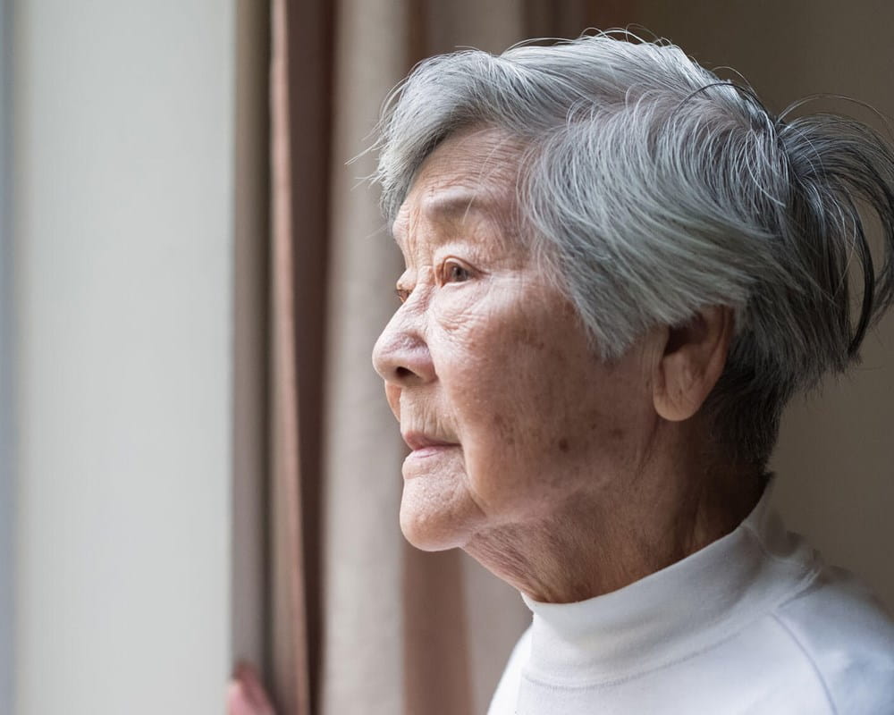 Older woman looking out the window