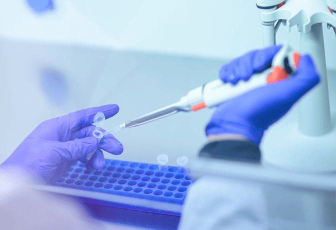 Gloved hands working in lab