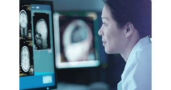 Asian female scientist looks at brain image