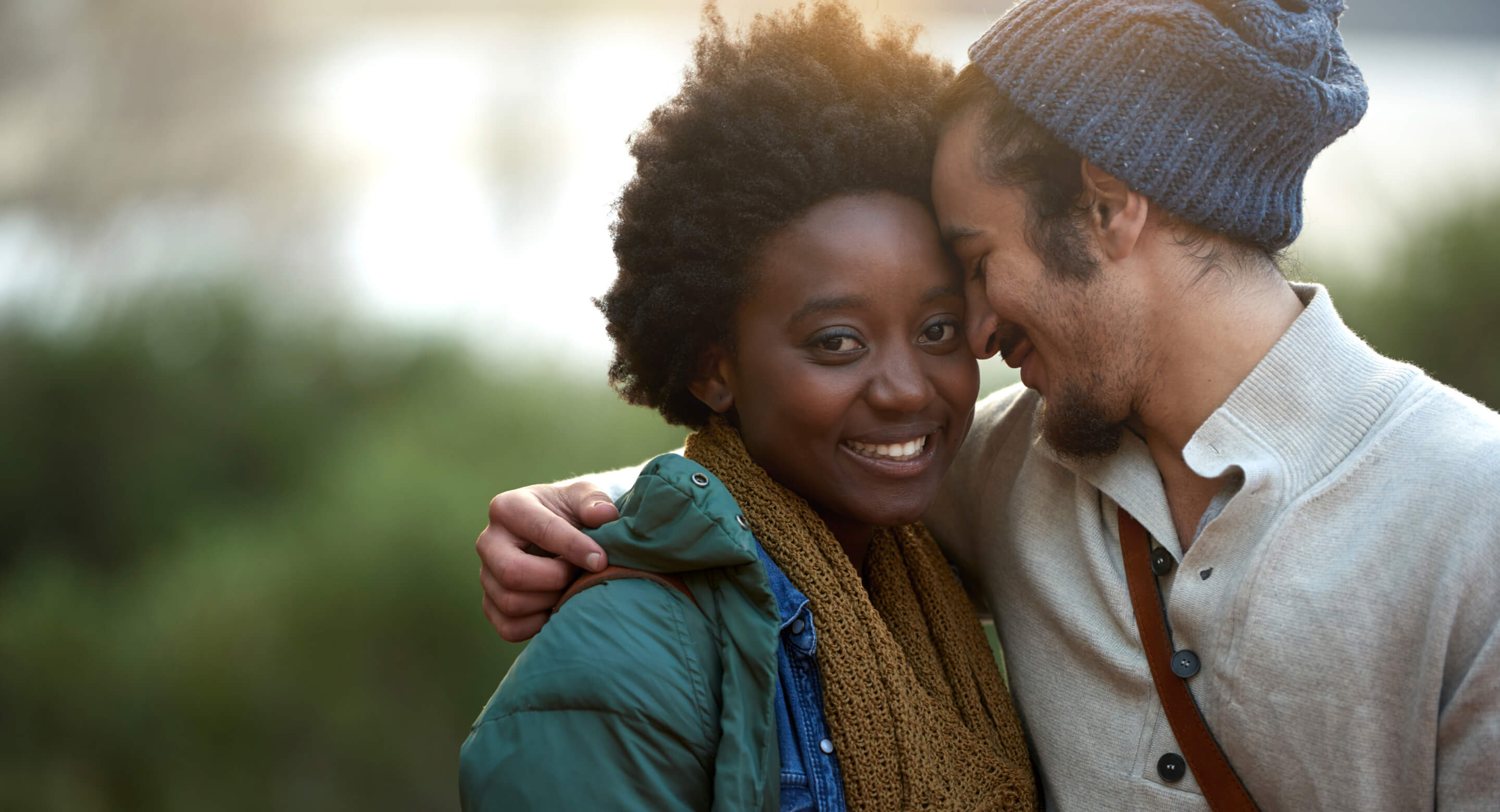 Man resting his forehead against a woman's head