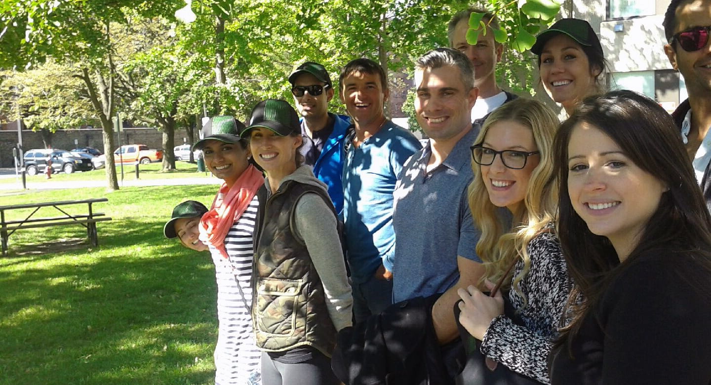 Corporate volunteers outside looking at the camera