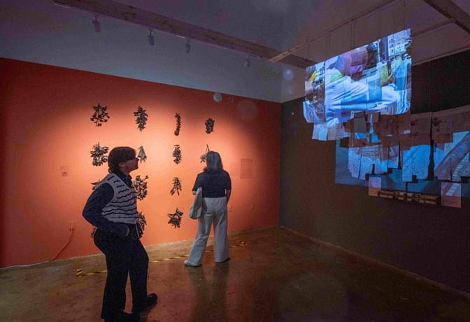 People viewing different art installations at the 2025 Being Scene exhibit presented by Workman Arts