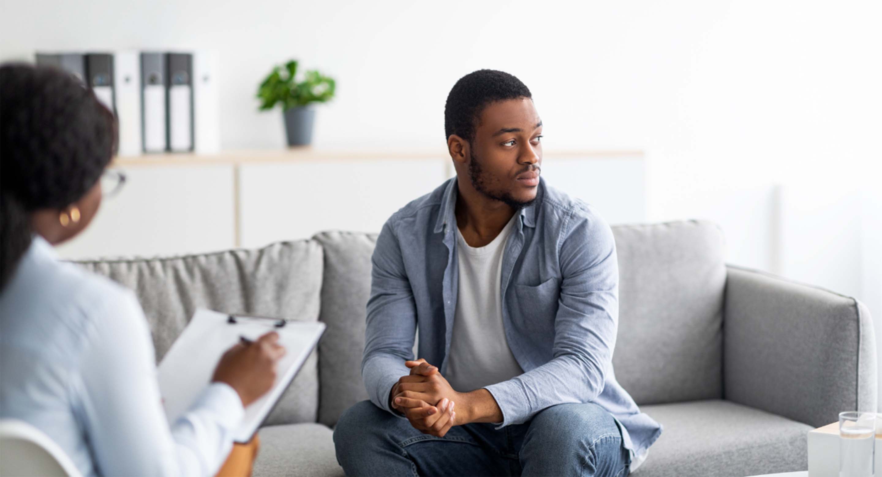 Person on a couch speaking with a therapist