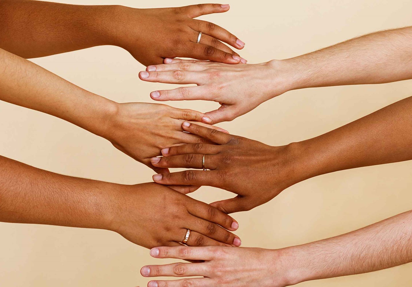 Photo of various women's hands holding each other
