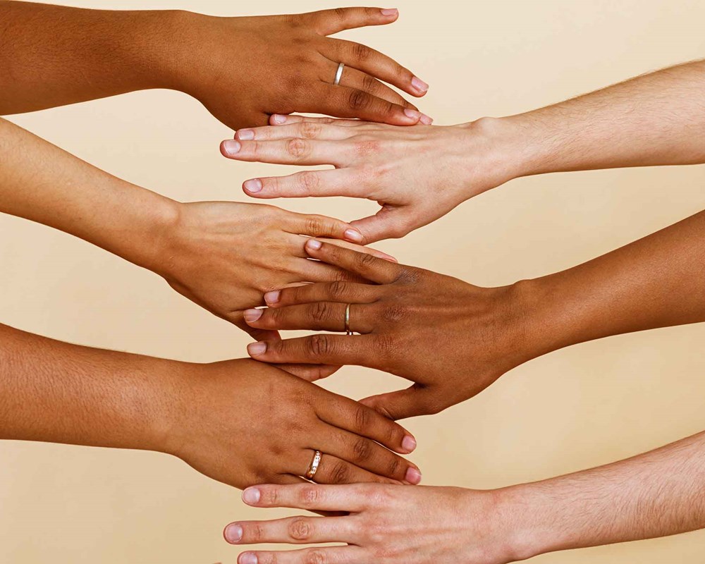 Photo of various women's hands holding each other