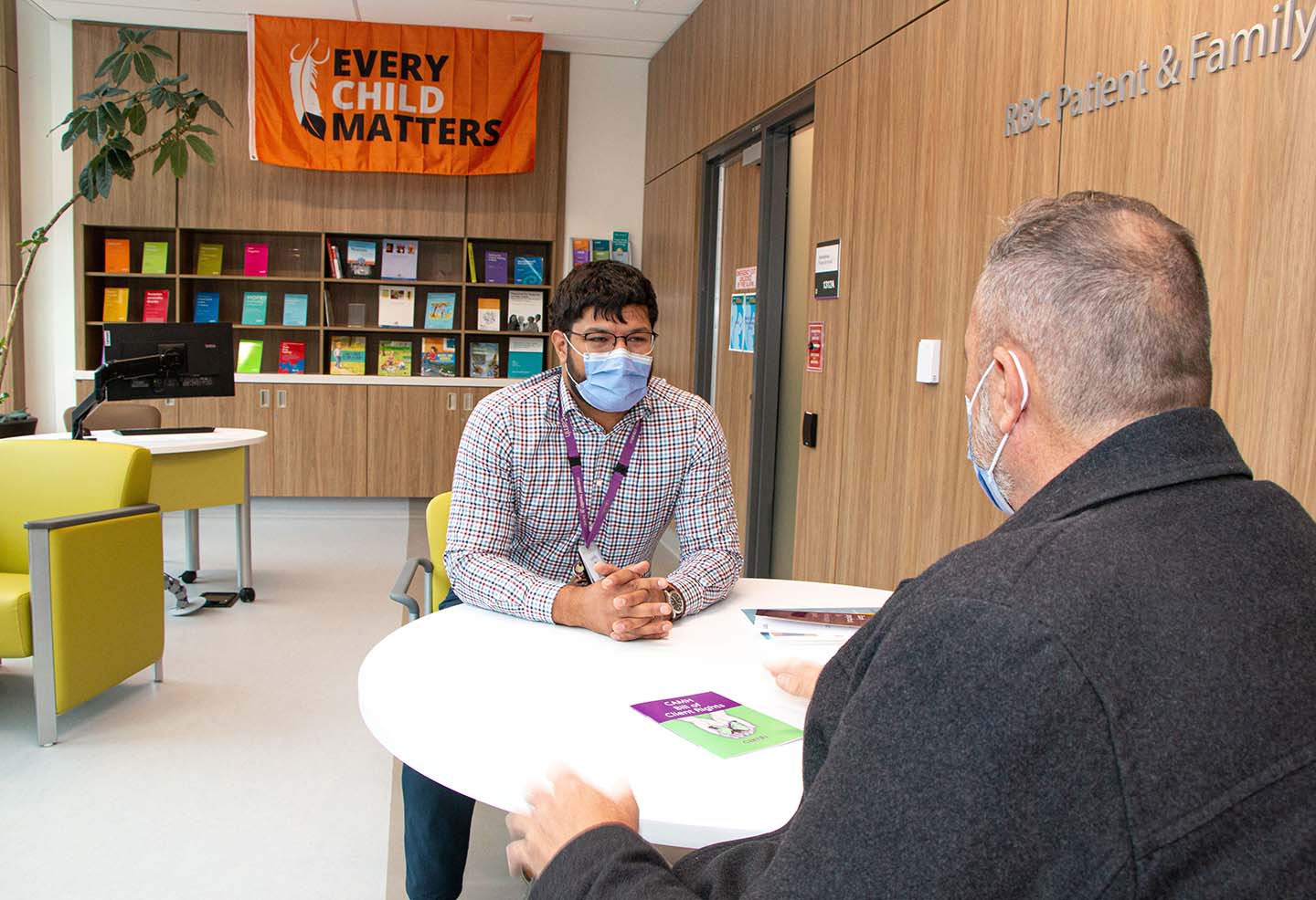 CAMH staff talking to a person at a table