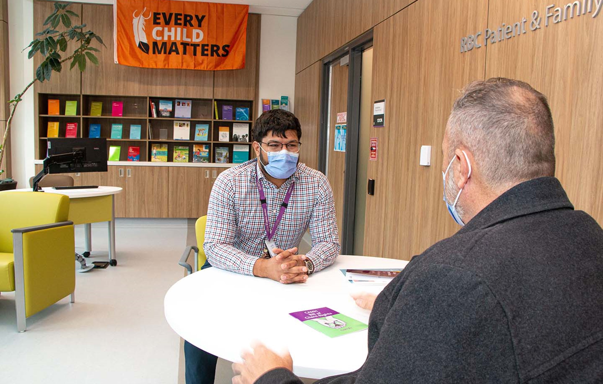 CAMH staff talking to a person at a table