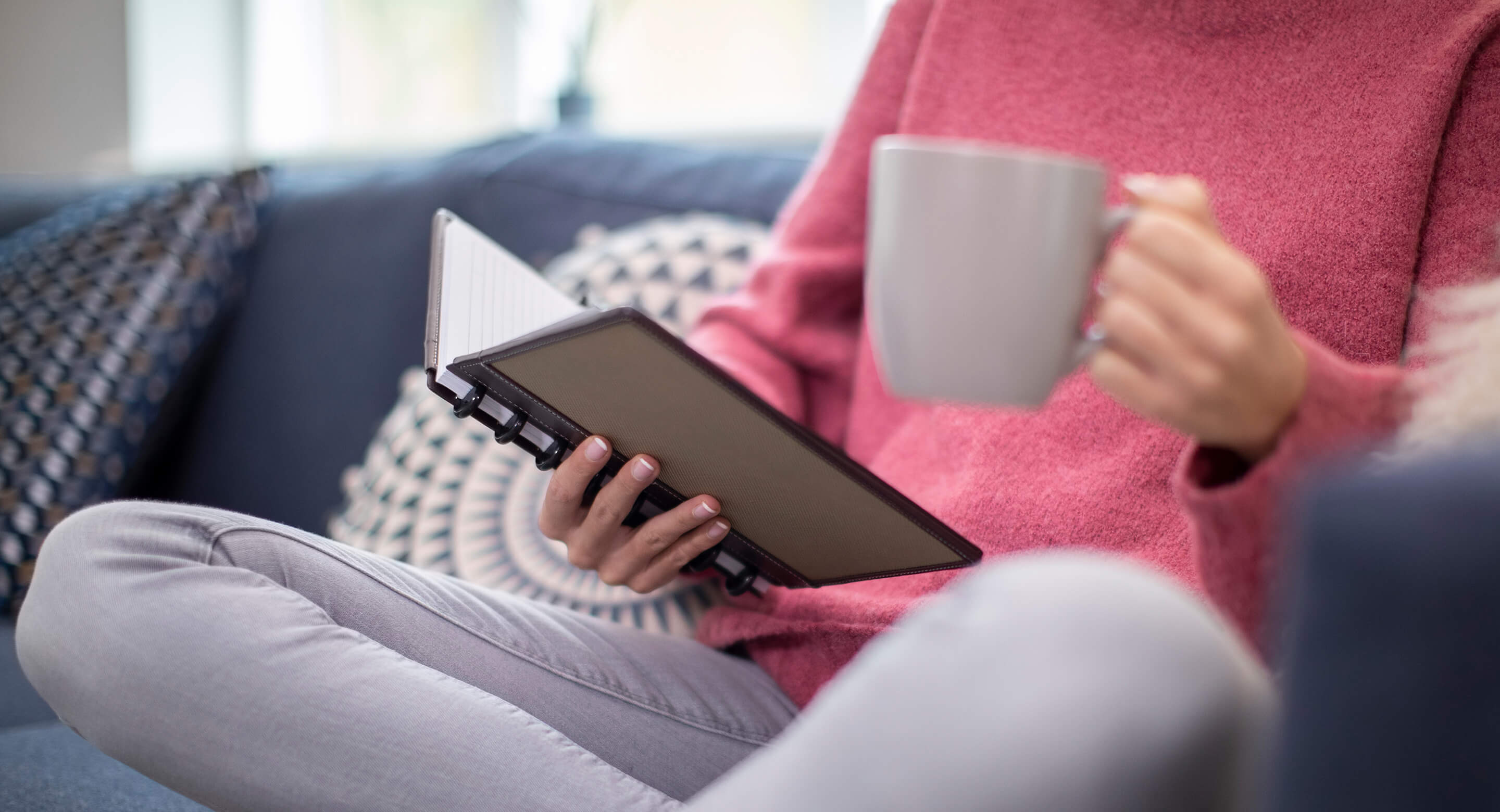 Woman relaxing reading a book and drinking tea