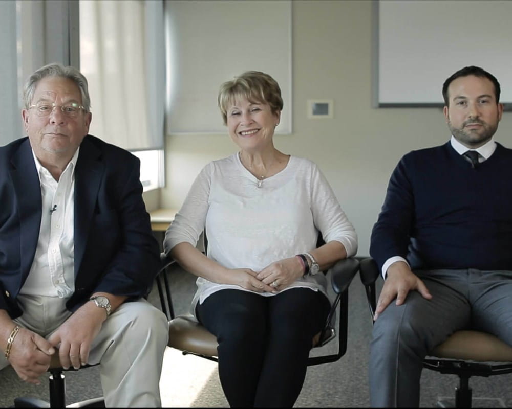 Three members of the Lewin family sitting in a row