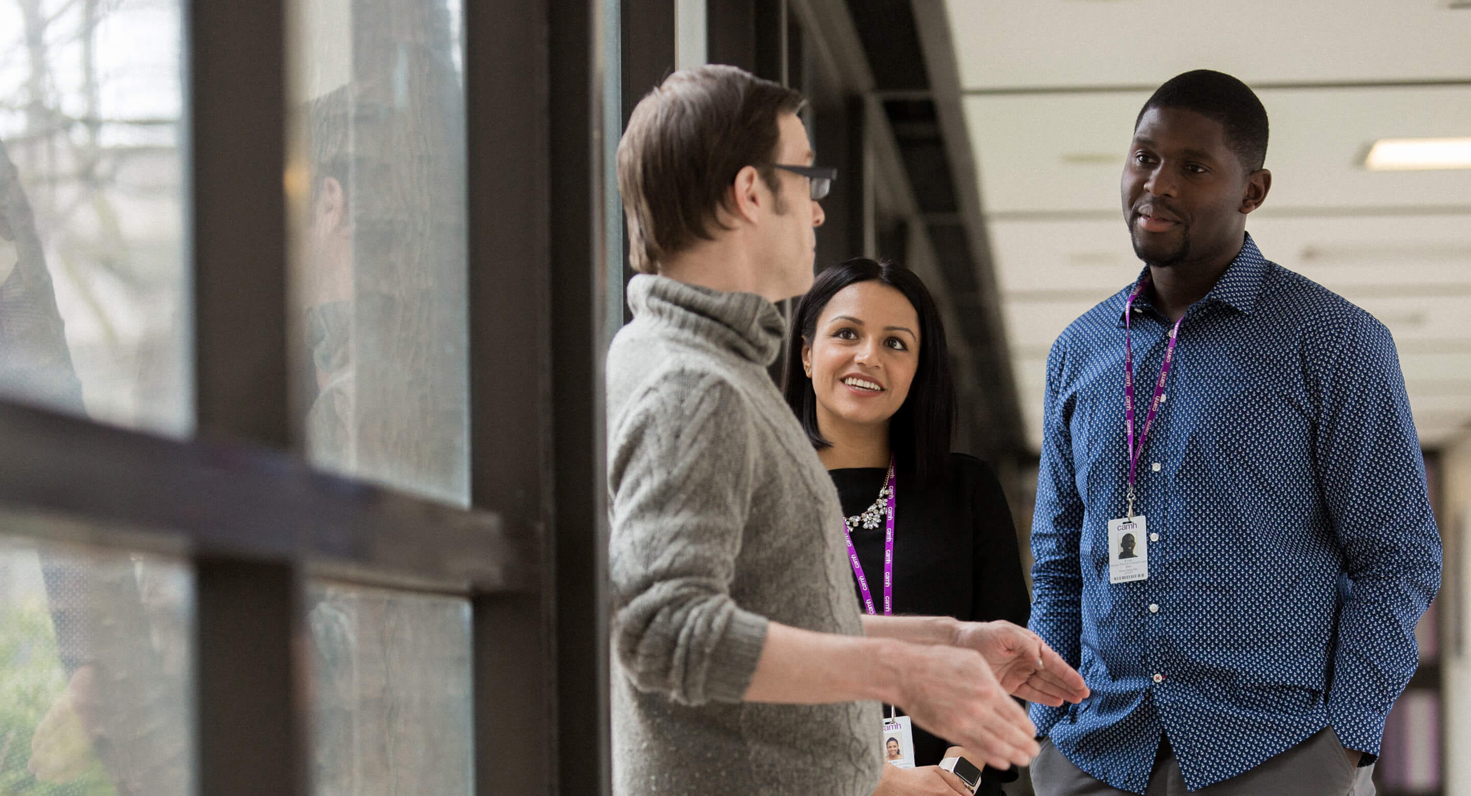 CAMH staff members converse in the hallway.