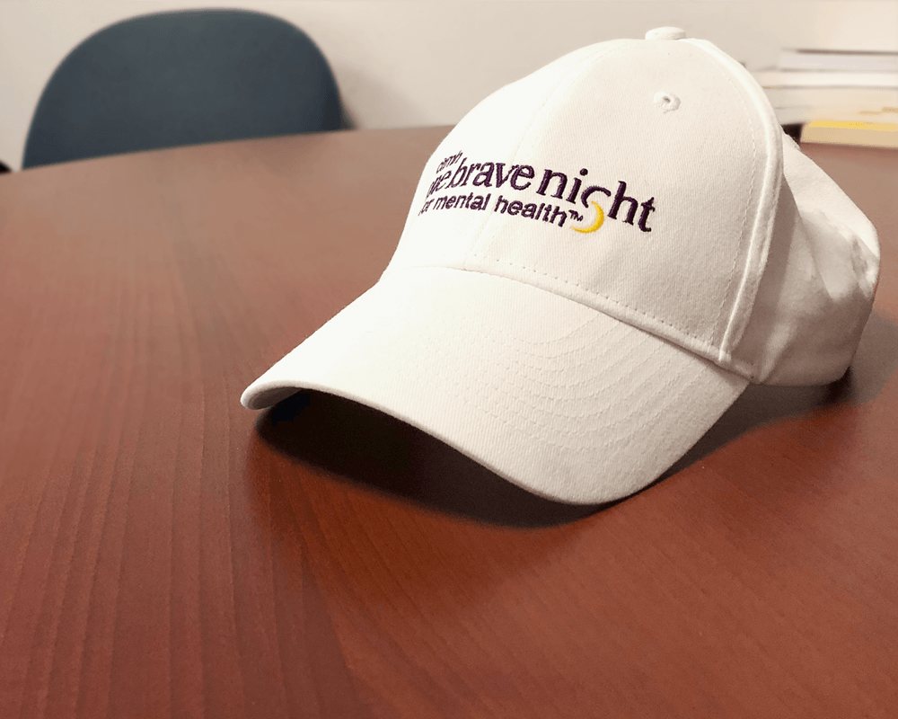 One Brave Night hat sits on table