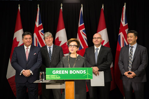 CEO, Catherine Zahn speaking in front of a podium with the sign 