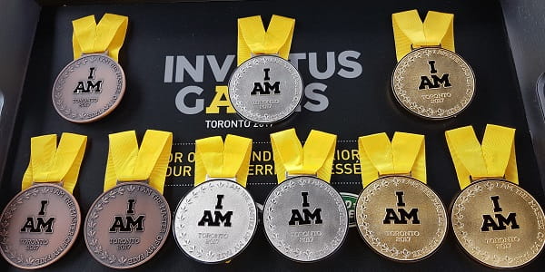 3 bronze, 3 silver, and 3 gold medals attached to a yellow ribbon with 