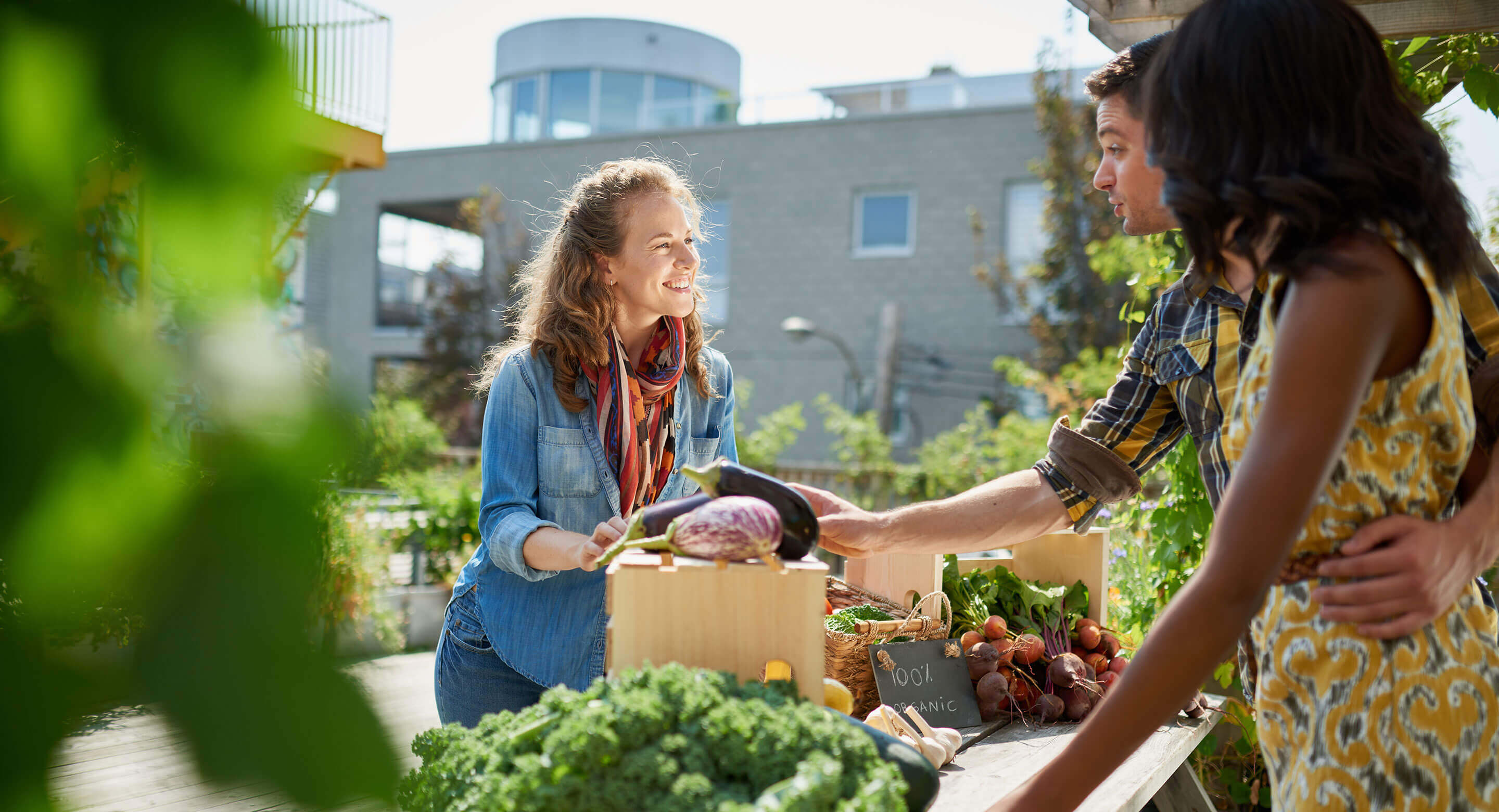 Couple talking to vendor at community Farmers Market.