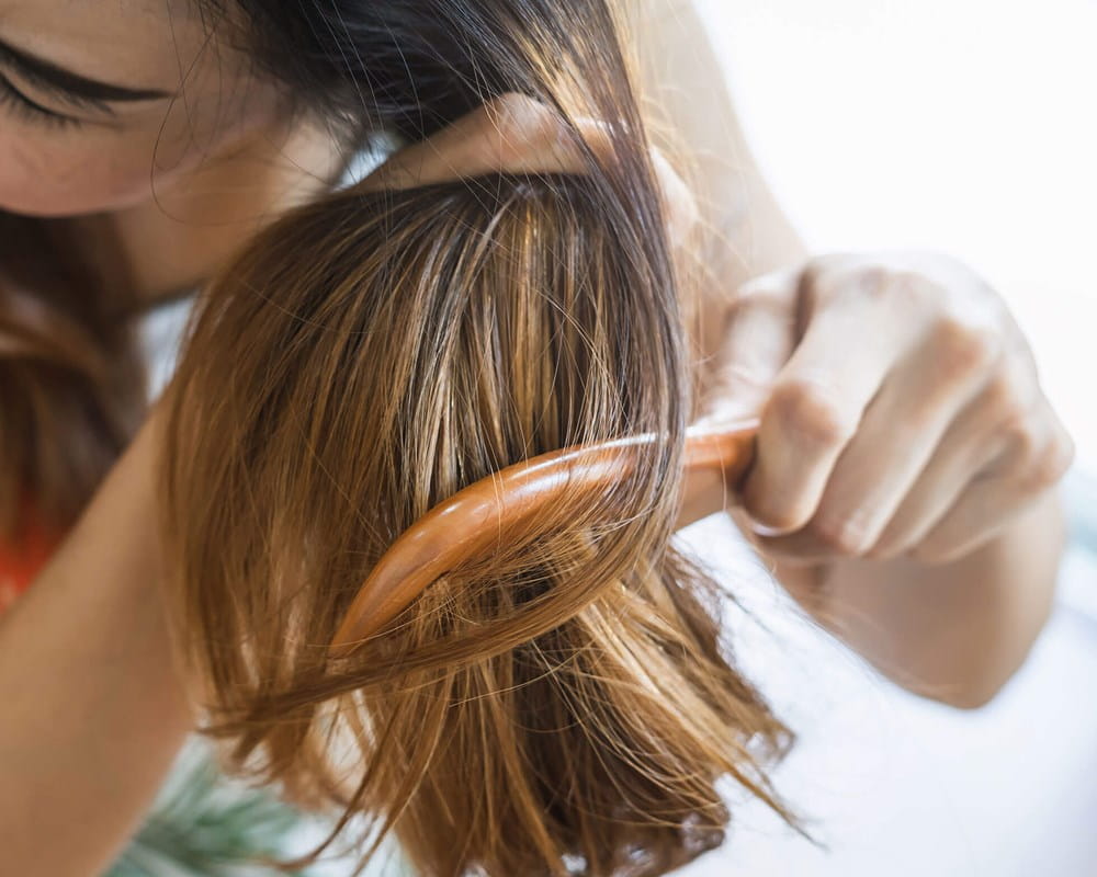 Woman brushing hair multiple times