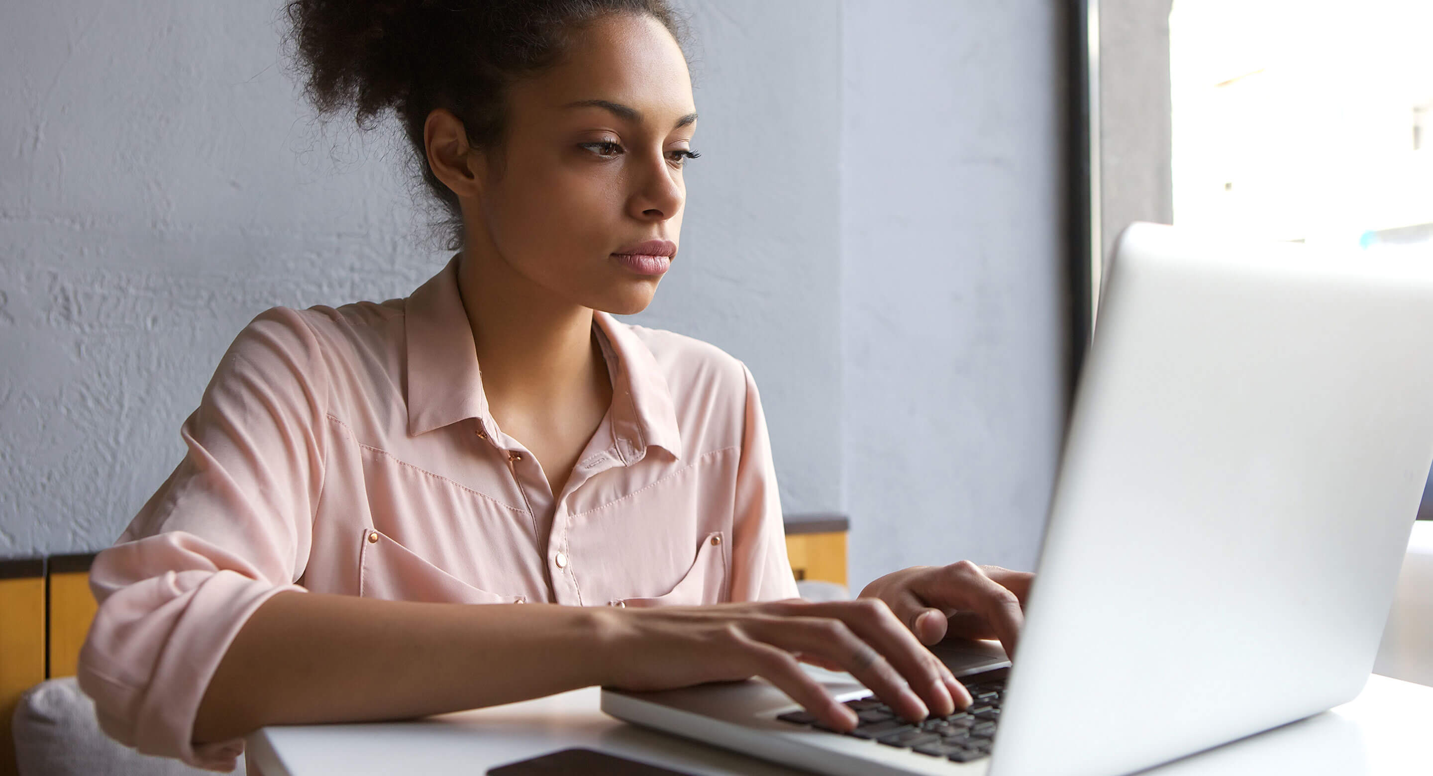 A young woman researches mental health on a computer