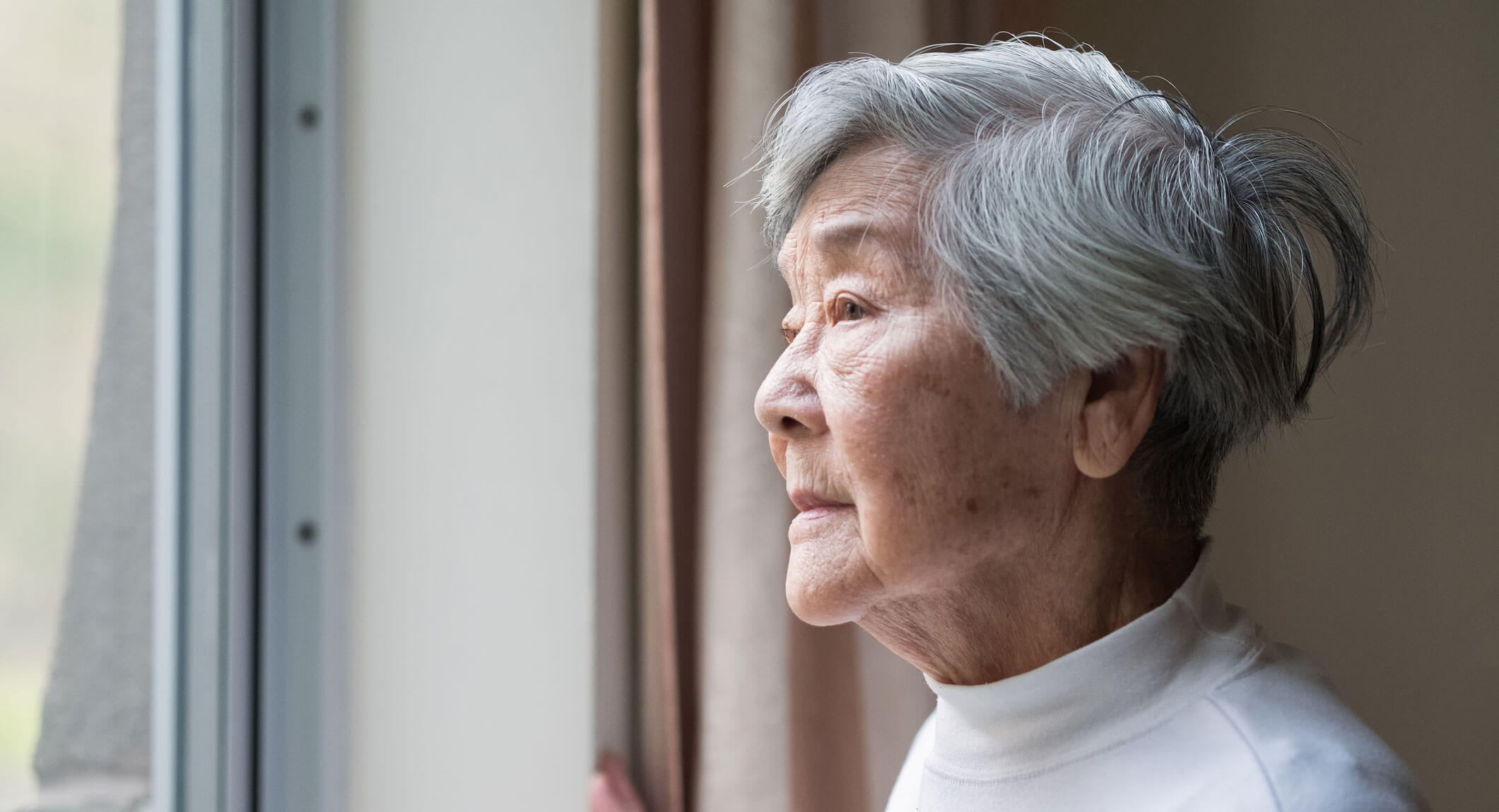 Older woman looking out the window
