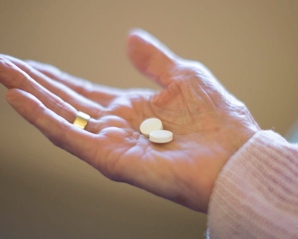 Woman's hand holding pills