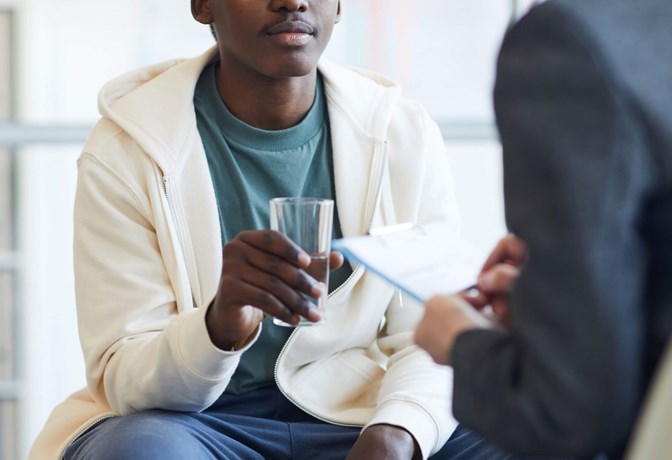 Stock photo of teenager in therapy session