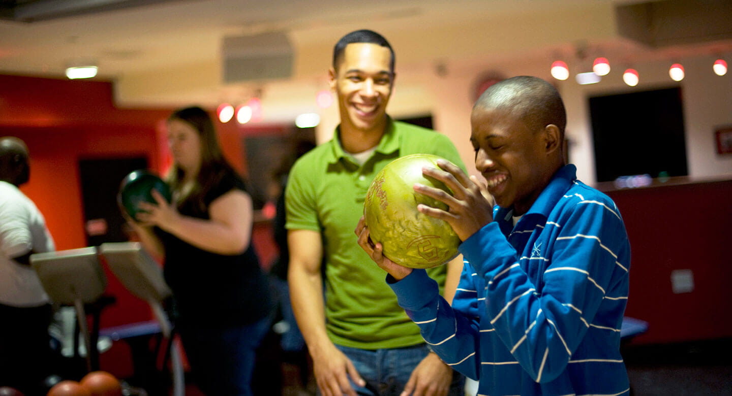 Happy young people bowling