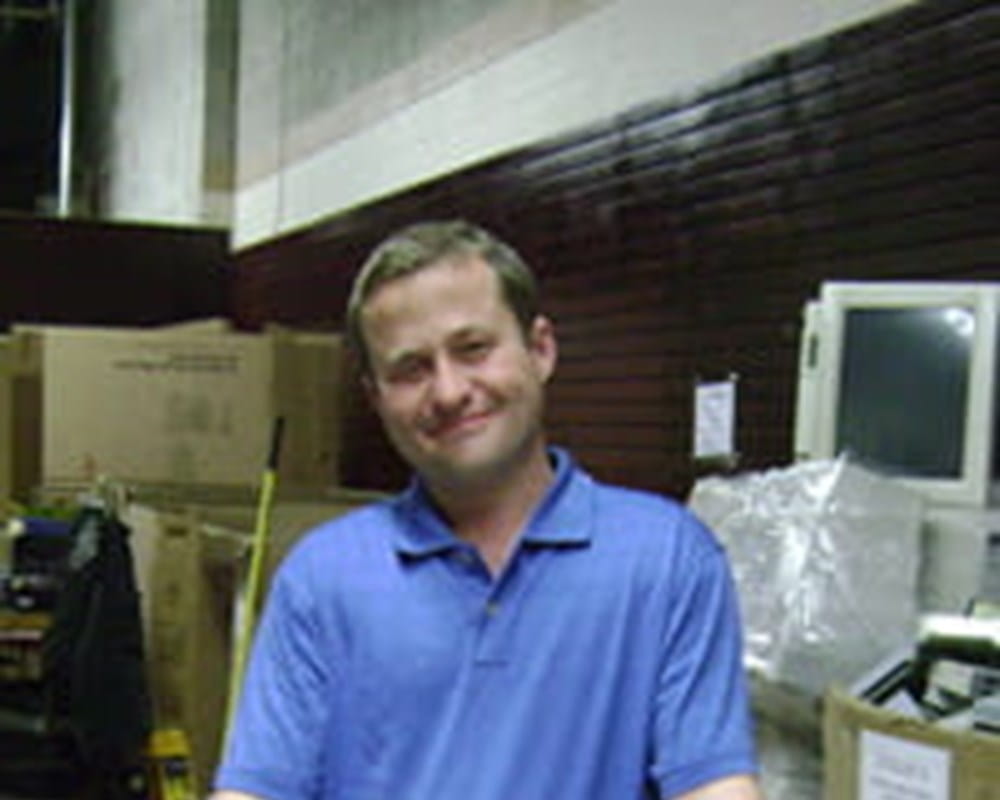 Pat carrying a cardboard box.