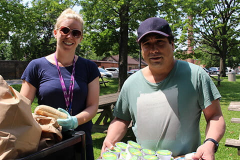 CAMH Recreation Therapist Janine Bakelaar and client Chris Lam get ready to hand out drinks for the CAMH CMI picnic program.