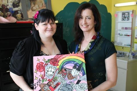 Valynn proudly displays a painting she made after leaving CAMH with her Recreational therapist. 