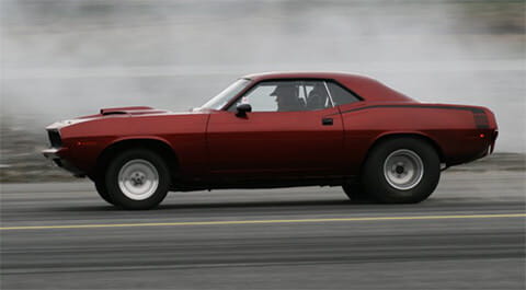 A red car racing through the streets.