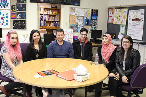 A diverse group of students sitting around a round table. 