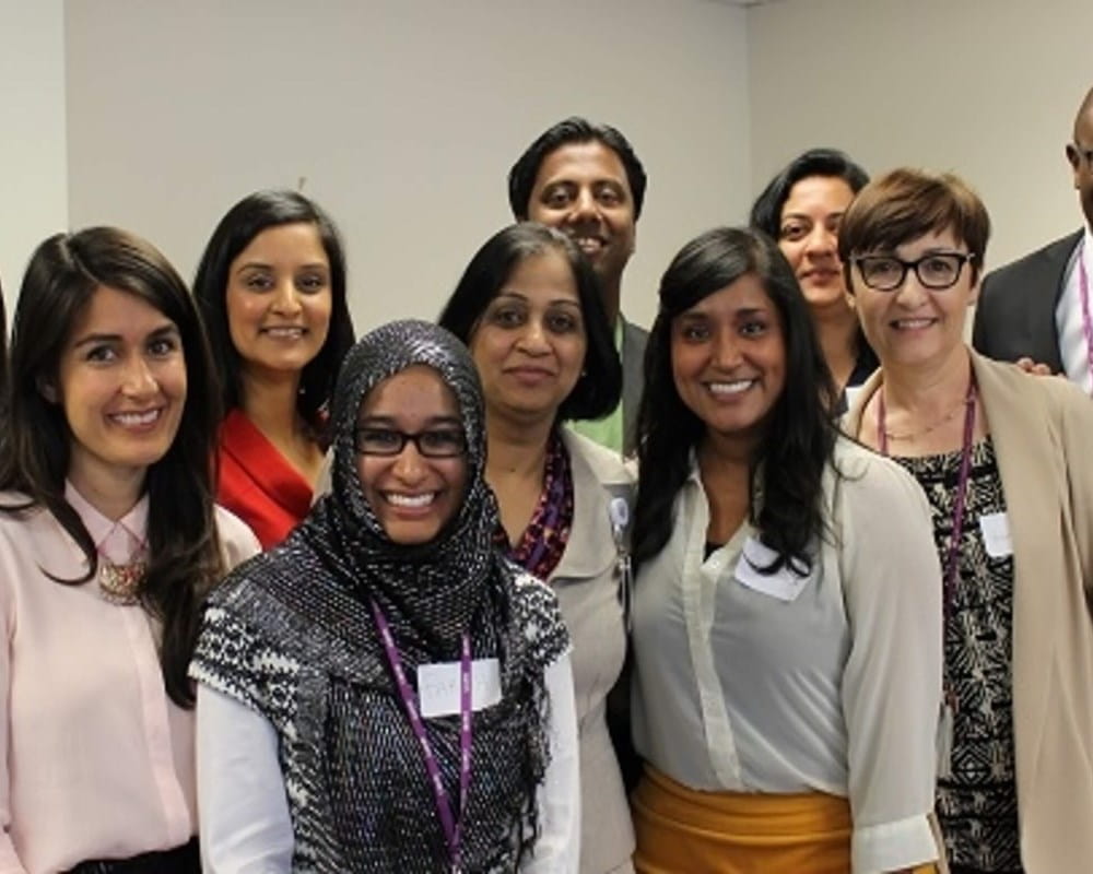 A diverse group of individuals smiling.