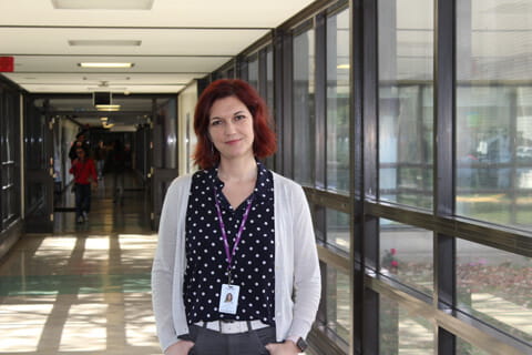 Dr. Yuliya Knyahnytska standing in a hallway.