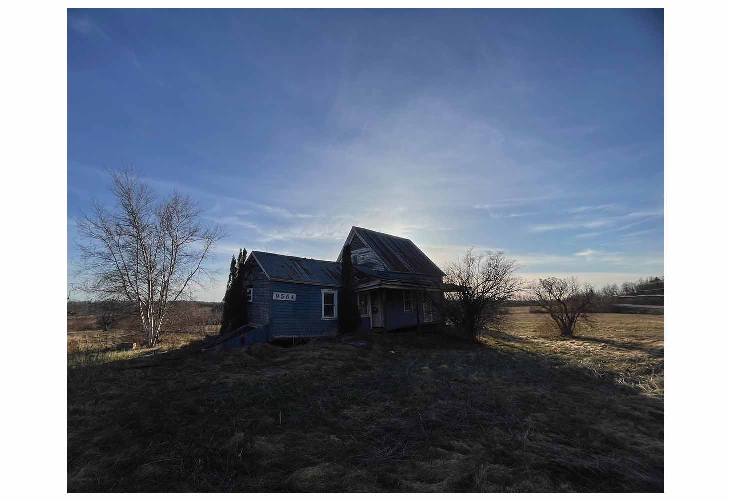 A an abandoned house in the middle of a rural area