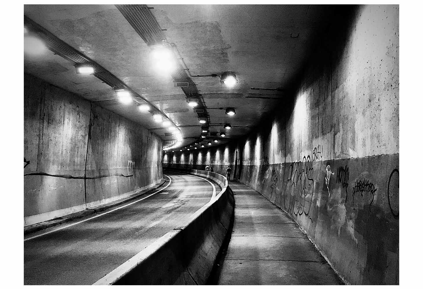 Black and white image of an empty tunnel