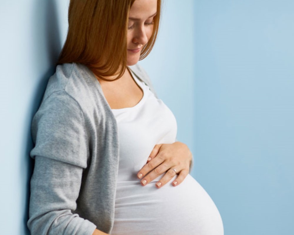 Image of a pregnant woman holding her belly
