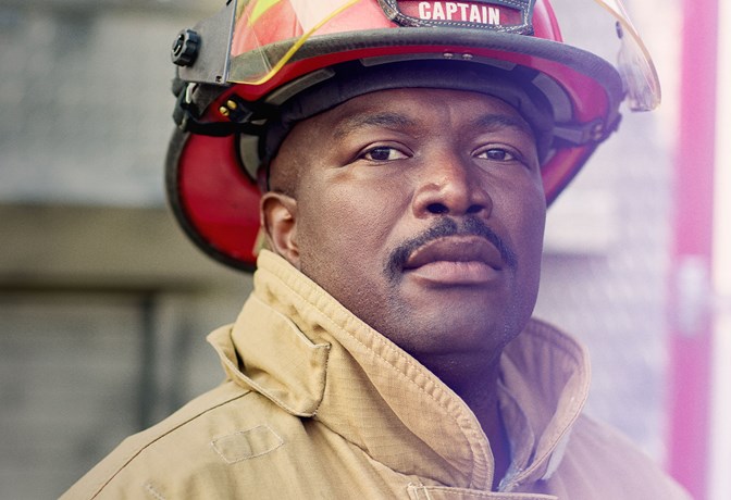 Middle-aged black fireman looking at camera