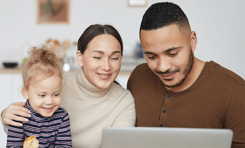 Happy family looking at laptop