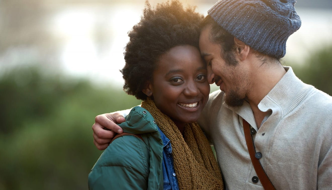 Man resting his forehead against a woman's head