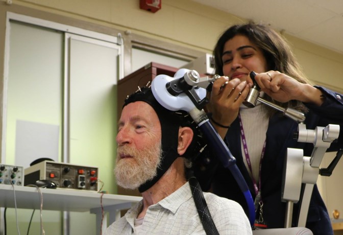 Don Palmer, a research volunteer, and Apoorva Bhandari, Research Analyst in Geriatric Psychiatry at CAMH, demonstrate the innovative, CAMH-developed approach to study brain plasticity in the frontal lobes