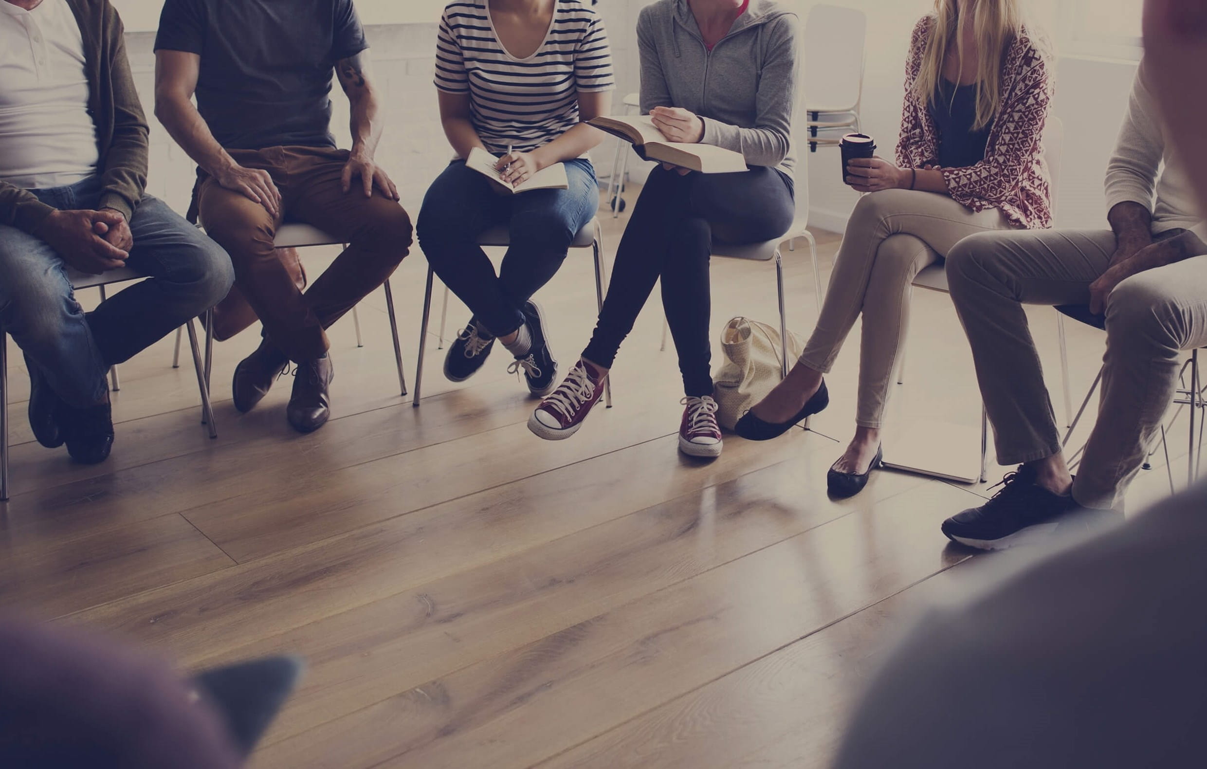 People sitting in a semi-circle with only their legs visible
