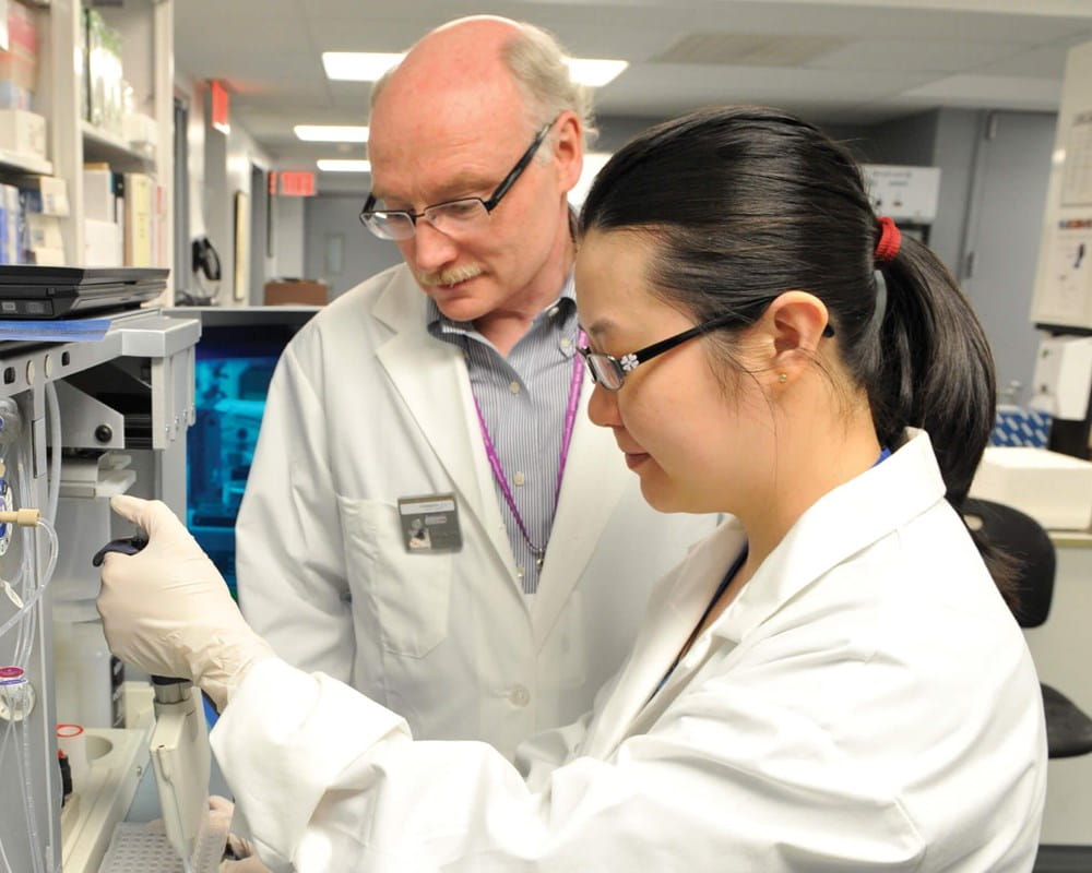Dr. Jim Kennedy and Dr. Gwyneth Zai in laboratory