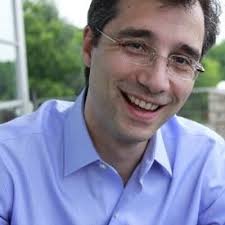 Close up profile photo of David Glatzer. He is in his mid 40s and smiling.