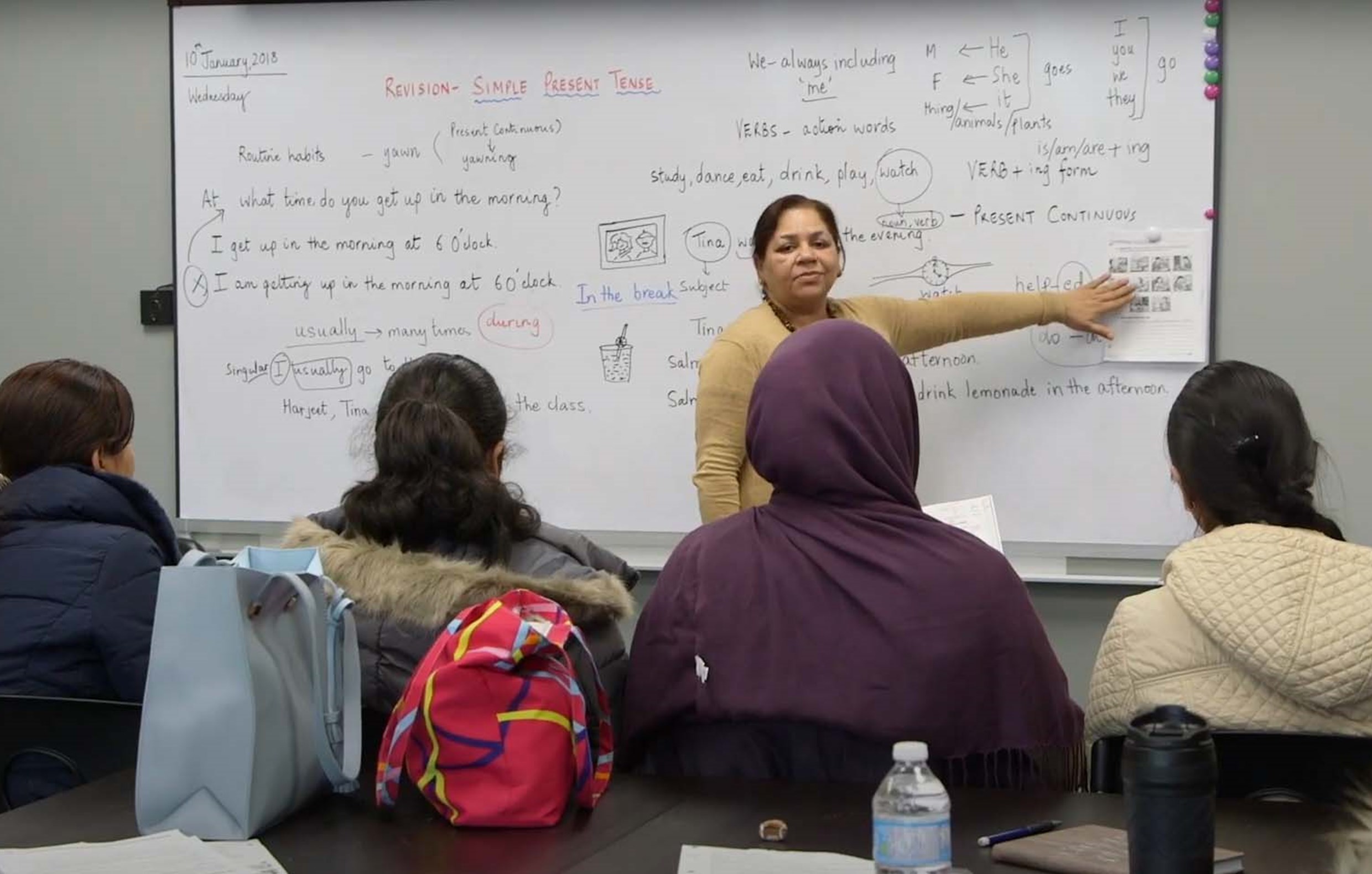 South Asian teacher teaching students