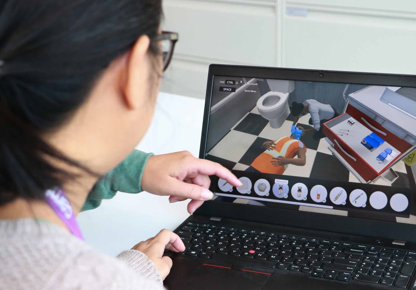 Person on a laptop going through a virtual reality training simulation