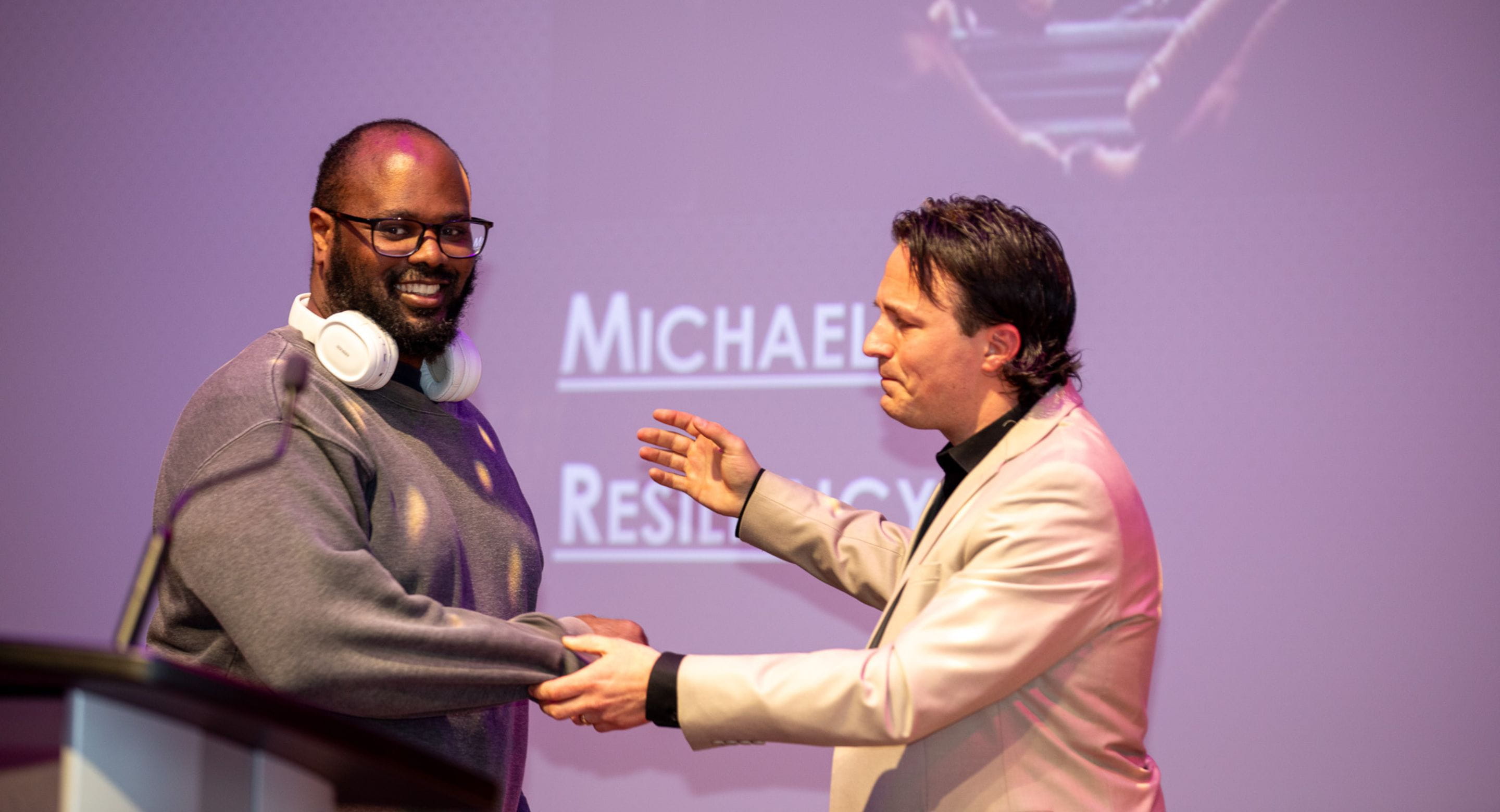 A FACT awards host reaches to hug a client
